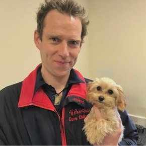 Cardiologist Dave Dickson holding a small dog