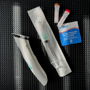 Black and white spaniel dog sat on veterinary weighing scales